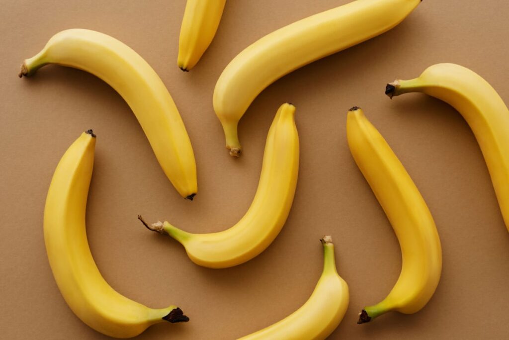 Ripe bananas on a surface, illustrating a dog food-safety article about bananas